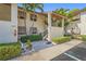 Condo exterior with well-kept landscaping and a walkway leading up to the entrance at 5275 Willow Links # 50, Sarasota, FL 34235