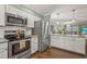 Well-equipped kitchen with stainless steel appliances and an island bar at 5275 Willow Links # 50, Sarasota, FL 34235