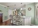 Kitchen island featuring granite countertops and pendant lighting with seating for two at 5275 Willow Links # 50, Sarasota, FL 34235