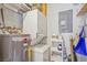 Efficient laundry room with stackable washer/dryer and storage shelving at 5275 Willow Links # 50, Sarasota, FL 34235