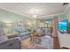 Bright living room with a glass door leading to the outdoor patio area, and comfortable seating at 5275 Willow Links # 50, Sarasota, FL 34235