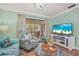 Inviting living room with stylish decor, a cozy armchair, and a view of the outdoor patio at 5275 Willow Links # 50, Sarasota, FL 34235