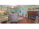 Cozy living room with a fireplace and an inviting view to other living spaces at 5275 Willow Links # 50, Sarasota, FL 34235
