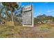 Sign for The Meadows Shopping Village, listing local businesses, set against a backdrop of palm trees and greenery at 5275 Willow Links # 50, Sarasota, FL 34235