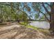 Picturesque waterfront view with walking path and mature trees at 5275 Willow Links # 50, Sarasota, FL 34235