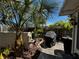 Outdoor patio featuring tropical plants, a barbecue grill, and decorative fountain for relaxation at 5378 Royal Palm Ave # 5378, Sarasota, FL 34234