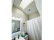 Bright bathroom featuring a skylight and updated vanity lighting at 5378 Royal Palm Ave # 5378, Sarasota, FL 34234