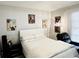 Well-lit bedroom featuring neutral paint, crisp white bedding, and elegant wall art at 5378 Royal Palm Ave # 5378, Sarasota, FL 34234