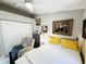 Bright bedroom with a ceiling fan, neutral paint, and cozy seating at 5378 Royal Palm Ave # 5378, Sarasota, FL 34234