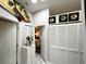 Hallway featuring decorative accents, adjacent to a bedroom and closet at 5378 Royal Palm Ave # 5378, Sarasota, FL 34234