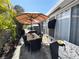 Inviting outdoor patio with dining set and an outdoor TV under a shade umbrella at 5378 Royal Palm Ave # 5378, Sarasota, FL 34234