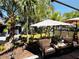 Inviting covered patio with comfortable outdoor seating, lush landscaping and lots of shade at 5378 Royal Palm Ave # 5378, Sarasota, FL 34234