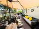 Cozy covered patio with comfortable seating, complete with plush cushions and vibrant plants at 5378 Royal Palm Ave # 5378, Sarasota, FL 34234