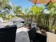 Backyard patio featuring a grill, covered table, and tropical landscaping creating a relaxing outdoor space at 5378 Royal Palm Ave # 5378, Sarasota, FL 34234