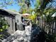 Outdoor backyard patio with a dining table, covered grill, and tropical foliage for a relaxing space at 5378 Royal Palm Ave # 5378, Sarasota, FL 34234
