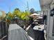 Landscaped outdoor patio with a covered grill and dining set under a large umbrella at 5378 Royal Palm Ave # 5378, Sarasota, FL 34234