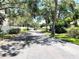Street view showing a well-maintained road lined with mature trees and landscaping at 5378 Royal Palm Ave # 5378, Sarasota, FL 34234