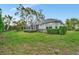 Screened-in lanai and lush backyard with well-maintained lawn and mature landscaping at 5508 Whitehead St, Bradenton, FL 34203