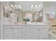 Bright bathroom featuring a double vanity, soaking tub, and a separate glass-enclosed shower at 5508 Whitehead St, Bradenton, FL 34203