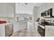 Bright kitchen featuring stainless steel appliances, white cabinetry and a decorative tile floor at 5508 Whitehead St, Bradenton, FL 34203