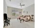 Cozy living room with comfortable sofa, ceiling fan, and natural light at 5508 Whitehead St, Bradenton, FL 34203