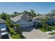 Beautiful single-Gathering home with a paved driveway, lush lawn, and tropical plants at 5621 Badini Way, Palmetto, FL 34221
