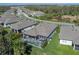 Aerial view of a home with a screened pool enclosure in a residential neighborhood at 5621 Badini Way, Palmetto, FL 34221