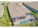 Aerial view of a home with a screened pool area, showcasing the outdoor living space at 5621 Badini Way, Palmetto, FL 34221