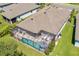 The home boasts a screened pool, outdoor seating, and manicured landscaping in this aerial view at 5621 Badini Way, Palmetto, FL 34221