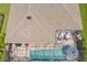 An aerial view of a beautiful home featuring a roof, screened-in pool and outdoor seating at 5621 Badini Way, Palmetto, FL 34221