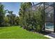 Backyard featuring a screened lanai and lush landscaping at 5621 Badini Way, Palmetto, FL 34221