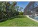 Lush green backyard with a screened enclosure at 5621 Badini Way, Palmetto, FL 34221