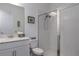 Bright bathroom featuring a glass-enclosed shower, white tile, and a sleek vanity with marble countertop at 5621 Badini Way, Palmetto, FL 34221