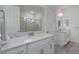 Modern bathroom with double vanity, marble countertops, and a glass-enclosed shower at 5621 Badini Way, Palmetto, FL 34221