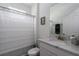 Well-lit bathroom featuring a vanity with a marble countertop, toilet, and a shower with a striped curtain at 5621 Badini Way, Palmetto, FL 34221