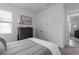 Neutral bedroom with a gray dresser, soft bedding, and a window allowing natural light at 5621 Badini Way, Palmetto, FL 34221
