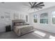 Comfortable bedroom with a ceiling fan and large windows allowing ample natural light at 5621 Badini Way, Palmetto, FL 34221