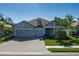 Charming single-Gathering home with a manicured lawn and a spacious two-car garage at 5621 Badini Way, Palmetto, FL 34221