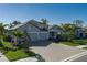 Beautiful single-story home with a paved driveway and tropical landscaping at 5621 Badini Way, Palmetto, FL 34221