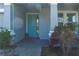 Inviting front entrance with a stylish blue door and decorative plants at 5621 Badini Way, Palmetto, FL 34221