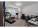 Versatile room with a treadmill, desk, and chair, perfect for a home office or gym at 5621 Badini Way, Palmetto, FL 34221