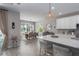 Bright, open-concept kitchen featuring a large island with marble countertops and modern pendant lighting at 5621 Badini Way, Palmetto, FL 34221