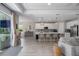 Open-concept living and kitchen area with ample seating and natural light at 5621 Badini Way, Palmetto, FL 34221