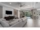 Stylish living room with a ceiling fan, wood-look tile floors, and a view of the screened-in pool at 5621 Badini Way, Palmetto, FL 34221