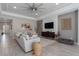 Bright living room featuring a stylish sectional sofa, modern decor, and wood-look tile flooring at 5621 Badini Way, Palmetto, FL 34221