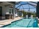Inviting screened pool area featuring in-pool seating and ample lounging space for relaxation and entertainment at 5621 Badini Way, Palmetto, FL 34221