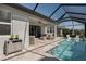 Outdoor pool area featuring a covered patio with comfortable seating and an inviting blue pool at 5621 Badini Way, Palmetto, FL 34221