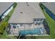 Aerial view of a screened-in pool and patio with furniture at 5621 Badini Way, Palmetto, FL 34221