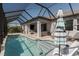 Screened pool area with patio seating and a covered lanai, perfect for outdoor entertaining and relaxation at 5621 Badini Way, Palmetto, FL 34221