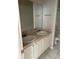 Bathroom with a double vanity, white cabinets, tile floors and a framed mirror at 5681 Bentgrass Dr # 13-201, Sarasota, FL 34235